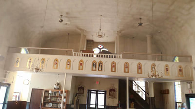 painting high ceilings of a church interior and choir loft