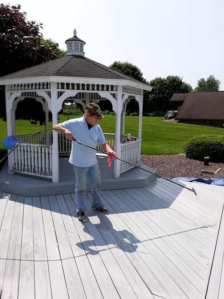 the owner painting gazebo and deck flooring