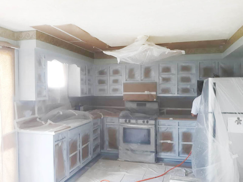 kitchen cabinets being painted during